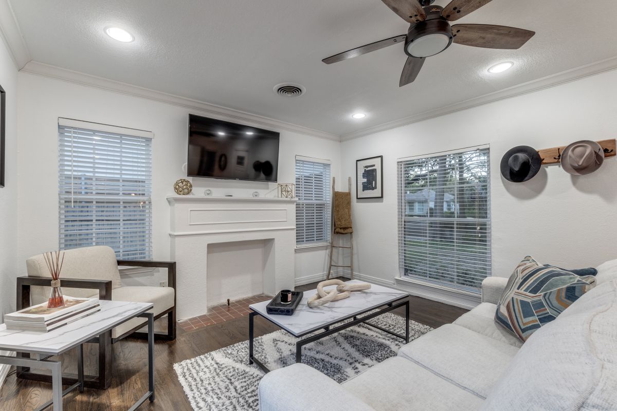 Unwind in your stylish living room featuring plush seating, a cozy fireplace, and modern amenities for the perfect evening retreat.