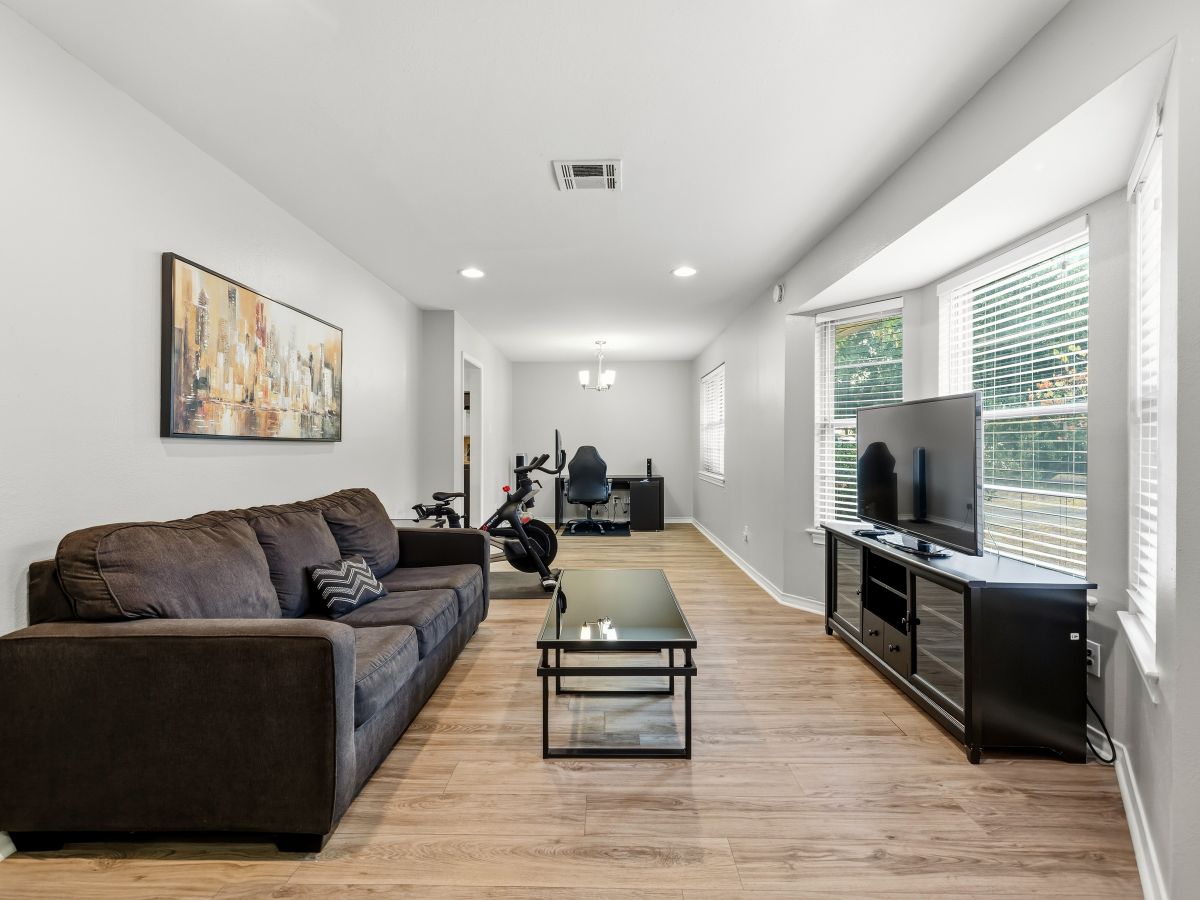 Stretch out in your bright, open living area with warm wood floors and modern comfort. Natural light pours in through expansive windows, creating the perfect space to unwind after exploring the area.