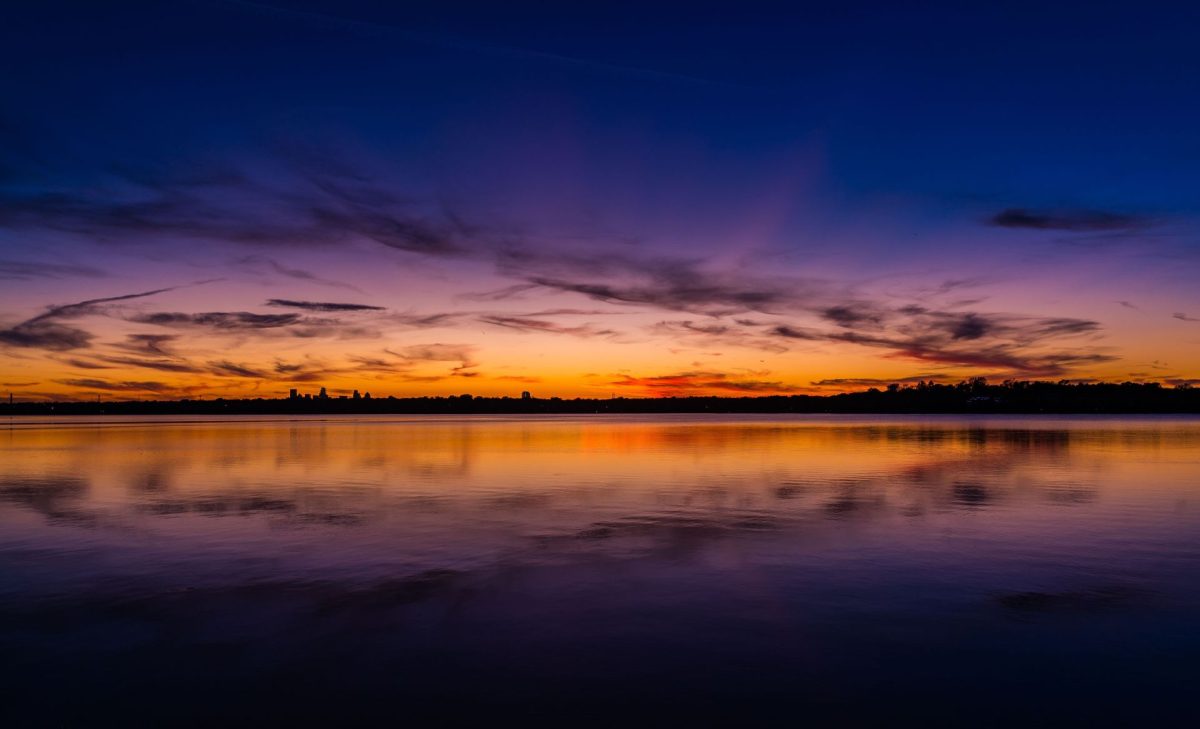A vibrant sunset with a spectrum of colors at White Rock Lake in Dallas, Texas.